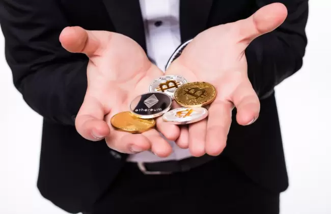 man-holds-different-crypto-coins-in-his-hands-on-white-1