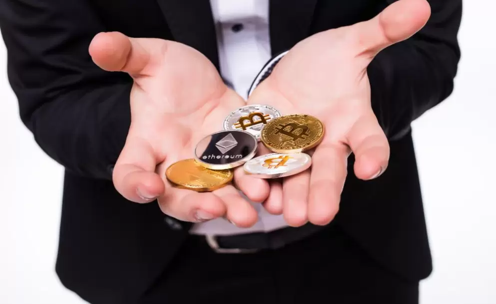 man-holds-different-crypto-coins-in-his-hands-on-white-1