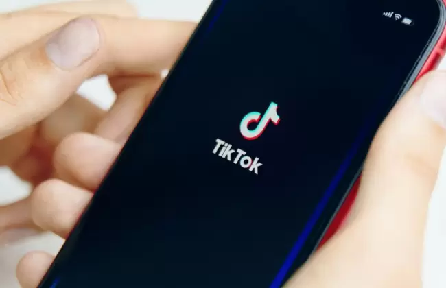 phone-in-hand-tik-tok-application-icon-on-phone-close-up