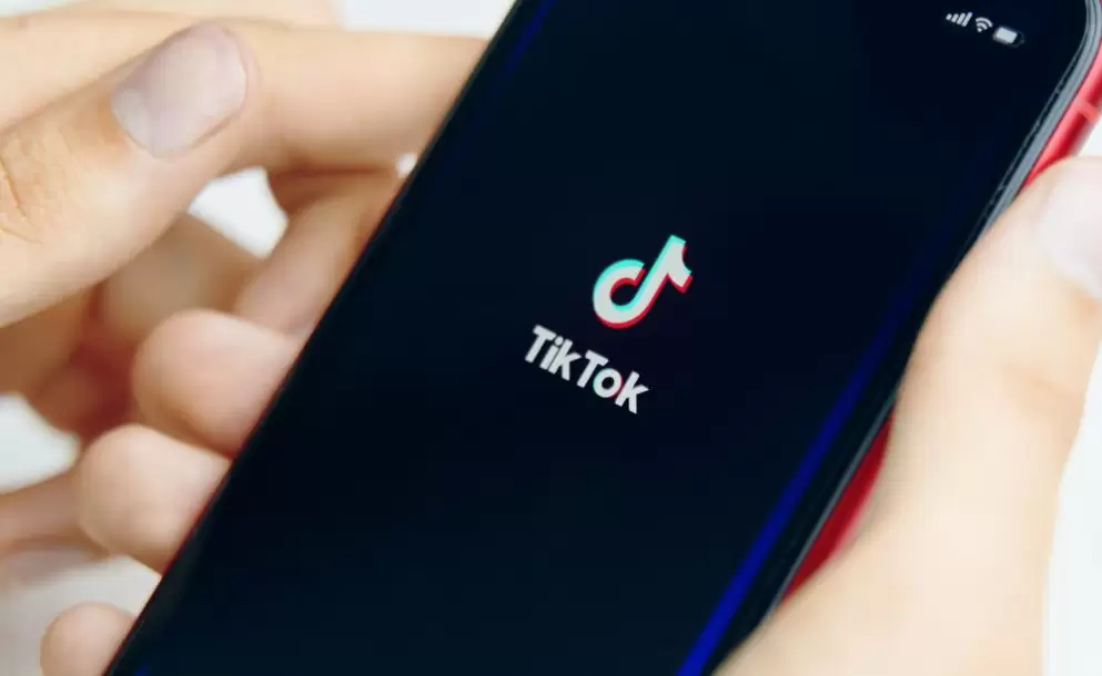 phone-in-hand-tik-tok-application-icon-on-phone-close-up