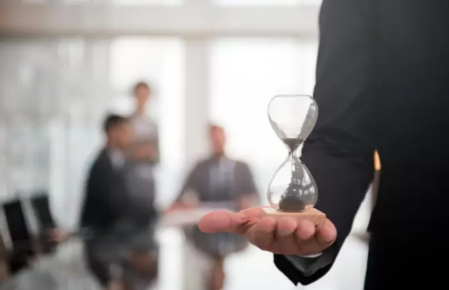 businessman-holding-an-hour-glass-signifies-the-importance-of-being-on-time