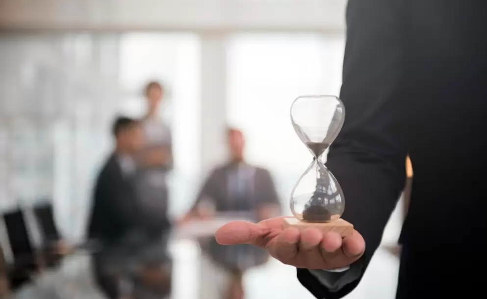 businessman-holding-an-hour-glass-signifies-the-importance-of-being-on-time