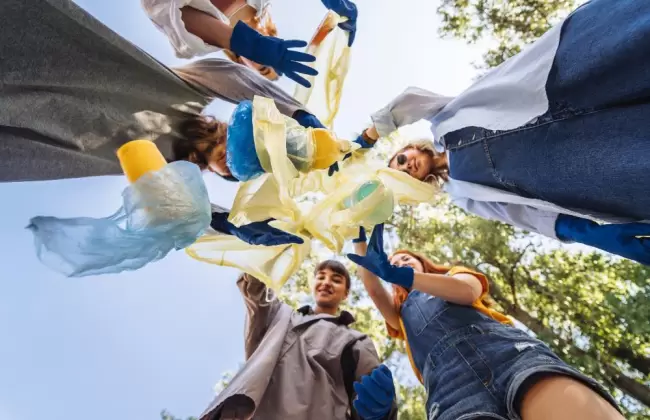 group-of-activists-friends-throw-lot-of-garbage-in-bag