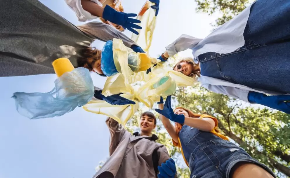 group-of-activists-friends-throw-lot-of-garbage-in-bag