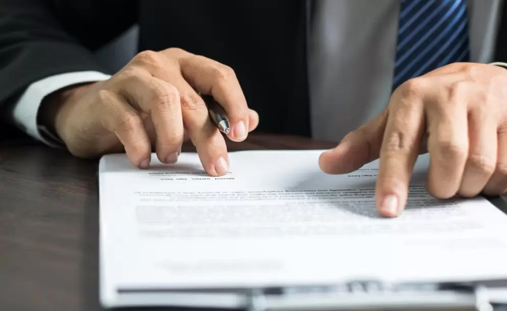 businessman-or-lawyer-reading-and-signing-on-contract-paper