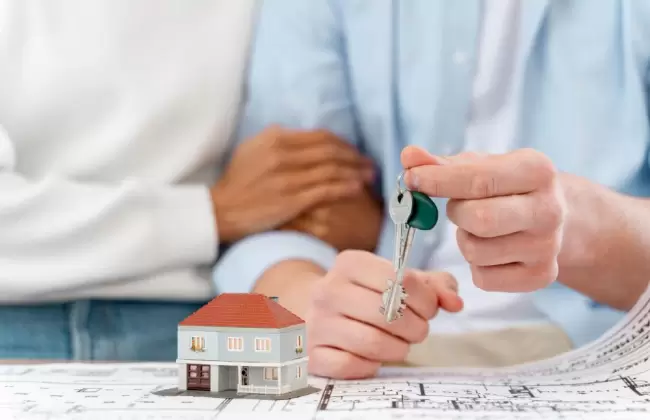 embraced-defocused-couple-holding-the-keys-to-their-new-house