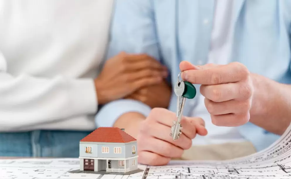 embraced-defocused-couple-holding-the-keys-to-their-new-house