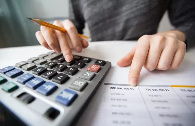 closeup-of-accountant-hands-counting-on-calculator