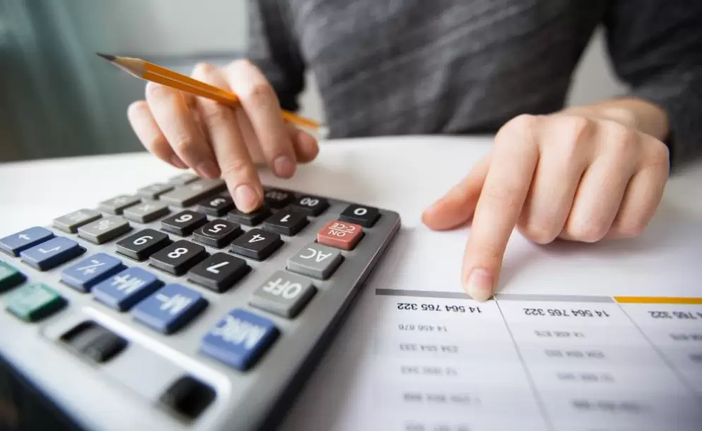 closeup-of-accountant-hands-counting-on-calculator